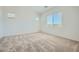 Bright bedroom with plush carpeting, a large window, and neutral walls at 16781 W Bronco Trl, Surprise, AZ 85387