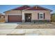 Charming single-story home featuring a two-car garage and low-maintenance desert landscaping at 16781 W Bronco Trl, Surprise, AZ 85387