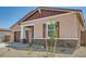 Attractive single-level house with a well-manicured front yard and inviting entry at 16781 W Bronco Trl, Surprise, AZ 85387