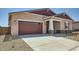 Beautiful home featuring a two-car garage, neutral color scheme, and easy-care desert landscaping at 16781 W Bronco Trl, Surprise, AZ 85387