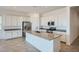 Modern kitchen featuring white cabinets, a stainless steel refrigerator, and a center island at 16781 W Bronco Trl, Surprise, AZ 85387