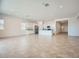 Bright, open-concept living space with tile flooring, a kitchen island and recessed lighting at 16781 W Bronco Trl, Surprise, AZ 85387