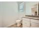 Bright powder room featuring a modern vanity, toilet, and neutral finishes at 16781 W Bronco Trl, Surprise, AZ 85387