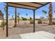 Backyard features gravel landscaping, palm trees, and covered patio at 17019 E Calaveras Ave, Fountain Hills, AZ 85268