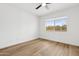 This bedroom boasts wood flooring and natural light from a window at 17019 E Calaveras Ave, Fountain Hills, AZ 85268
