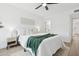 Cozy bedroom with bright white bedding, accent throw, and light wood flooring at 17019 E Calaveras Ave, Fountain Hills, AZ 85268