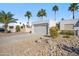 The home's exterior features desert landscaping, mature palm trees, and a two car garage at 17019 E Calaveras Ave, Fountain Hills, AZ 85268