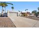 This home has desert landscaping, a long drive way, and mature palm trees at 17019 E Calaveras Ave, Fountain Hills, AZ 85268