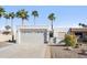 Charming single-story home featuring desert landscaping, palm trees, and a two-car garage at 17019 E Calaveras Ave, Fountain Hills, AZ 85268