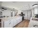 Bright, open kitchen features white cabinets, stainless appliances, and a large island with seating at 17019 E Calaveras Ave, Fountain Hills, AZ 85268