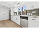 A well-lit kitchen featuring white cabinetry, stainless steel appliances, and quartz countertops at 17019 E Calaveras Ave, Fountain Hills, AZ 85268