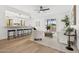 Open living area with an island kitchen, light wood floors, and sliding glass doors to the backyard at 17019 E Calaveras Ave, Fountain Hills, AZ 85268