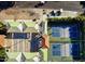 An aerial view of tennis courts and shade ramadas with adjacent parking at 17718 N Desert Flower Trl, Surprise, AZ 85374