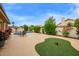 Well-manicured backyard with a sparkling pool, lush landscaping, and comfortable lounge chairs at 17718 N Desert Flower Trl, Surprise, AZ 85374