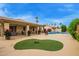 Expansive backyard featuring a sparkling pool, well manicured landscaping, and covered patio at 17718 N Desert Flower Trl, Surprise, AZ 85374