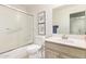 Bright bathroom featuring a shower over tub and a single sink vanity at 17718 N Desert Flower Trl, Surprise, AZ 85374
