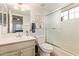 Clean bathroom featuring a single sink vanity, shower over tub and tile flooring at 17718 N Desert Flower Trl, Surprise, AZ 85374