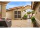 Covered courtyard featuring tiled flooring, seating, and a wrought iron gate at 17718 N Desert Flower Trl, Surprise, AZ 85374