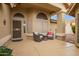 Cozy covered patio with seating, tiled flooring, and a view of the backyard at 17718 N Desert Flower Trl, Surprise, AZ 85374