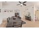 Open dining area with a large table, tile floors, and access to the kitchen and living spaces at 17718 N Desert Flower Trl, Surprise, AZ 85374