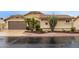 Charming single-story home featuring a tile roof, desert landscaping, and a two-car garage at 17718 N Desert Flower Trl, Surprise, AZ 85374