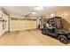 Spacious garage featuring ample storage, a golf cart, and an insulated garage door at 17718 N Desert Flower Trl, Surprise, AZ 85374