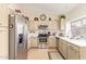 Bright kitchen with stainless steel appliances, tile floors, and crisp countertops at 17718 N Desert Flower Trl, Surprise, AZ 85374