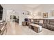 Spacious living room featuring a brown leather sectional, neutral tones, and an open floor plan at 17718 N Desert Flower Trl, Surprise, AZ 85374