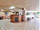 Inviting lobby area featuring a reception desk, cozy seating, and tile flooring at 17718 N Desert Flower Trl, Surprise, AZ 85374