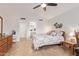 Spacious main bedroom featuring tile flooring and an open en suite bathroom at 17718 N Desert Flower Trl, Surprise, AZ 85374