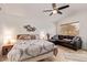 Main bedroom featuring a sitting area, ceiling fan, and tile flooring at 17718 N Desert Flower Trl, Surprise, AZ 85374