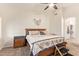 Cozy main bedroom with neutral tones, carpet flooring, and a ceiling fan at 17718 N Desert Flower Trl, Surprise, AZ 85374