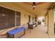 Covered patio with ceiling fan, outdoor seating, and view of the backyard space at 17718 N Desert Flower Trl, Surprise, AZ 85374