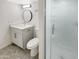 Bathroom with a shower with glass doors, tile flooring, modern vanity, round mirror, and sleek fixtures at 1913 N Verano Way, Chandler, AZ 85224