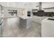 Modern kitchen featuring a large island, white countertops, and stainless steel appliances at 1913 N Verano Way, Chandler, AZ 85224