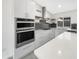 Modern kitchen featuring stainless steel appliances, white countertops, and ample cabinet space at 1913 N Verano Way, Chandler, AZ 85224