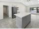 Bright kitchen with a spacious island, stainless steel refrigerator, and modern cabinetry at 1913 N Verano Way, Chandler, AZ 85224