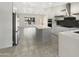 Well-lit kitchen featuring stainless steel appliances, a spacious island, and stylish cabinetry at 1913 N Verano Way, Chandler, AZ 85224