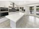 Bright modern kitchen with island and black backsplash and view of pool through windows at 1913 N Verano Way, Chandler, AZ 85224