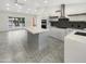 Modern kitchen with white cabinets, stainless steel appliances, and a large center island at 1913 N Verano Way, Chandler, AZ 85224