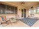 Comfortable covered back patio with ceiling fan and cozy seating, ideal for relaxing and entertaining at 19537 E Thornton Rd, Queen Creek, AZ 85142