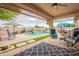 Relaxing back patio with a pool, outdoor seating, and well-maintained landscaping, perfect for outdoor enjoyment at 19537 E Thornton Rd, Queen Creek, AZ 85142