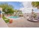 Resort-style backyard showcasing a sparkling pool, lush landscaping, and a decorative fountain at 19537 E Thornton Rd, Queen Creek, AZ 85142