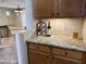 Convenient bar area with granite countertops, wood cabinets, and open sight lines at 19537 E Thornton Rd, Queen Creek, AZ 85142