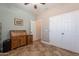 Bedroom or flex room, featuring a large window, shutters, desk and book shelves, with view to other room at 19537 E Thornton Rd, Queen Creek, AZ 85142