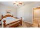 Comfortable bedroom with a ceiling fan, closet and an ensuite bath at 19537 E Thornton Rd, Queen Creek, AZ 85142