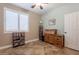 Bedroom or flex room, featuring a large window, shutters, desk and book shelves at 19537 E Thornton Rd, Queen Creek, AZ 85142