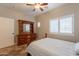 Bright bedroom with a ceiling fan, shuttered windows, and a wooden dresser at 19537 E Thornton Rd, Queen Creek, AZ 85142