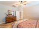 This angle showcases a bedroom with earth-tone walls, tile floor and a dresser with mirror at 19537 E Thornton Rd, Queen Creek, AZ 85142
