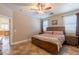Comfortable bedroom featuring a ceiling fan, tile flooring, and a well-lit, inviting atmosphere at 19537 E Thornton Rd, Queen Creek, AZ 85142